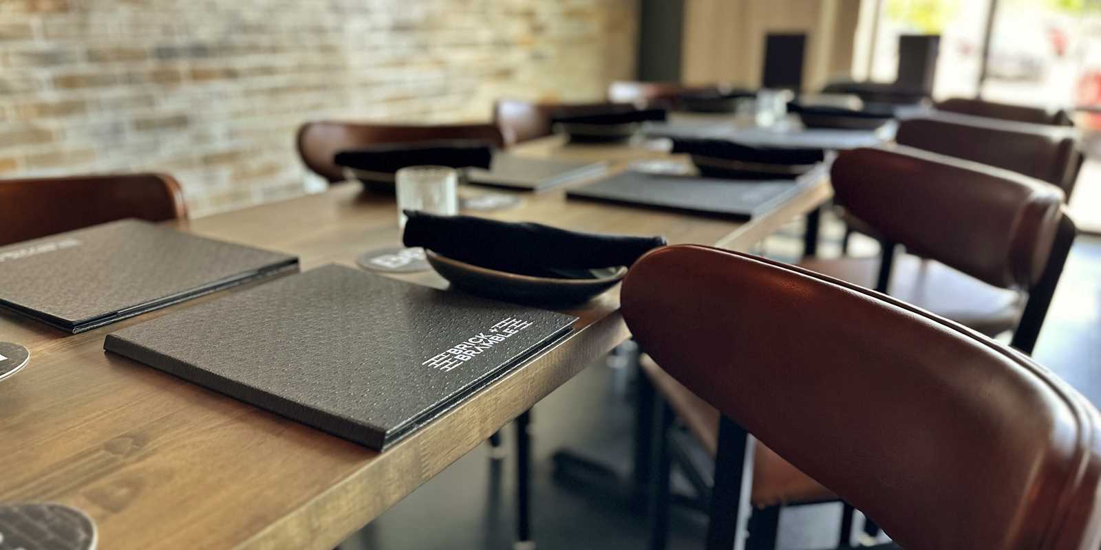 chair and table arrangement with menus and place settings