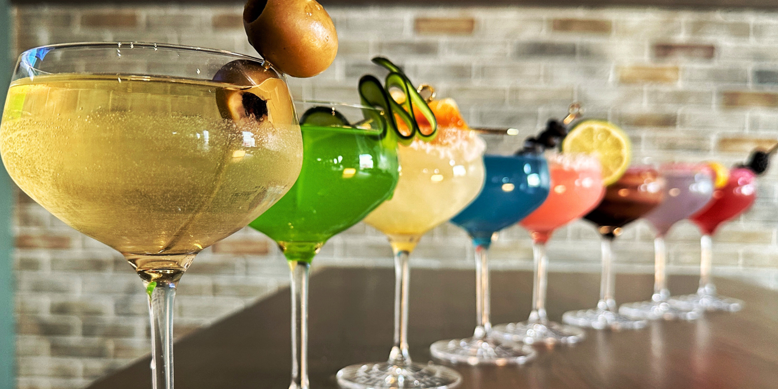 Martinis of various colors with many different garnishes